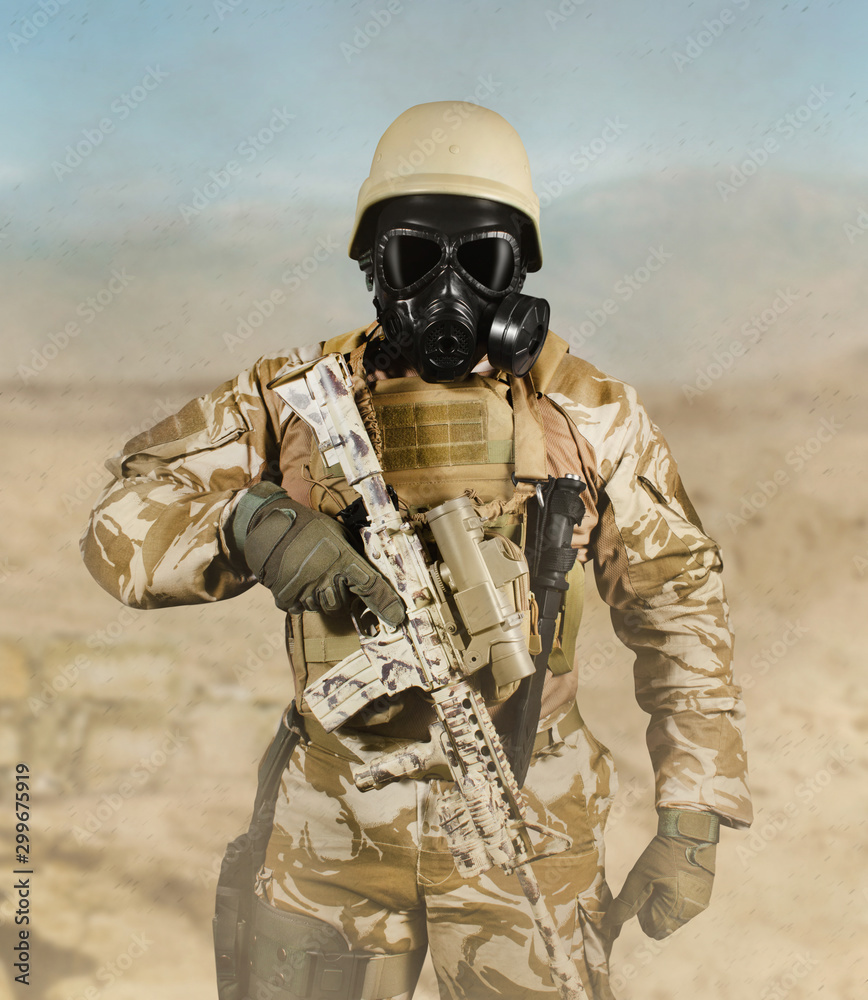 Fully equipped desert soldier in gas mask, armor and rifle standing on  desert background. Photos | Adobe Stock