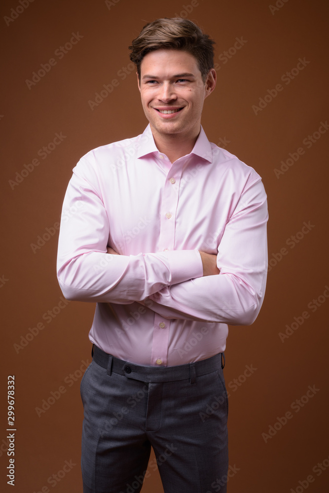 Studio shot of young handsome businessman with pink shirt Studio shot of young handsome businessman with pink shirt