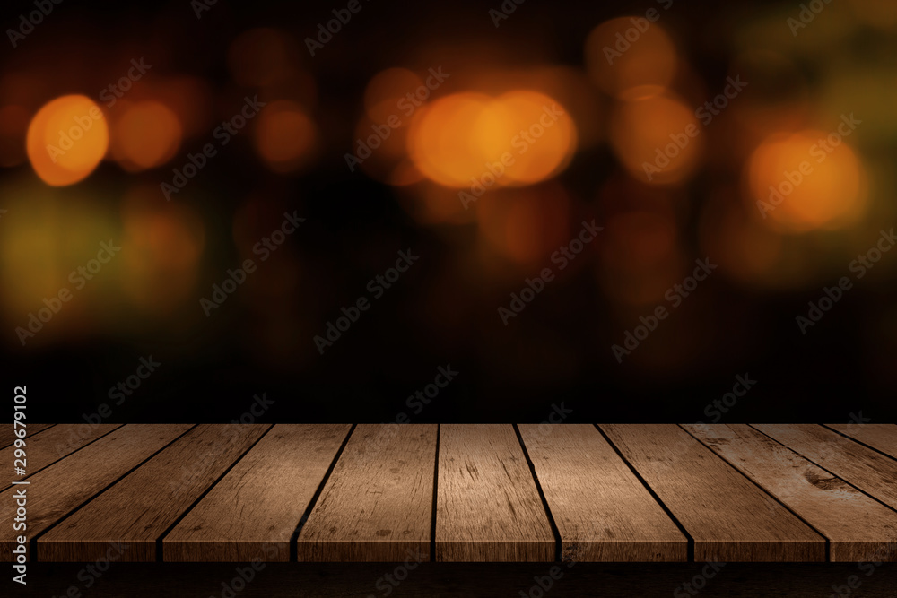 Wooden table with a view of blurred beverages bar backdrop. Blur cafe and restaurant with abstract bokeh light background. For create montage product display - obrazy, fototapety, plakaty 