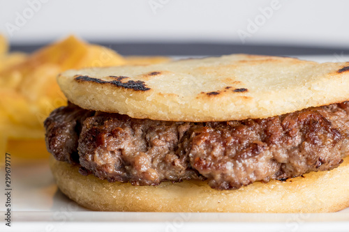 arepa with meat and fried green banana
