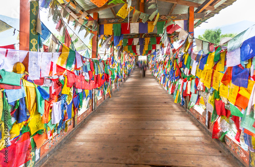 Colorful Buddhist prayer flags on wooden bridge walk way to Monastery in Thimpu, Bhutan