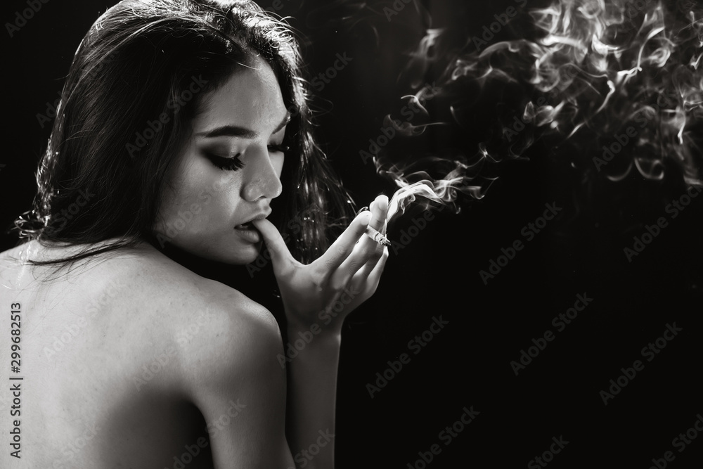 Sexy woman smoking cigarette with smoke black space for text low