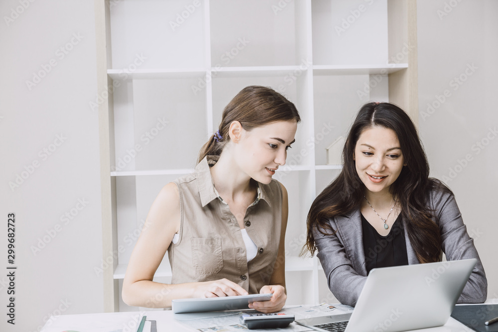 Business women helping together looking take care for training new employee with friendly in office life. Business women helping together looking take care for training new employee with friendly in office life.