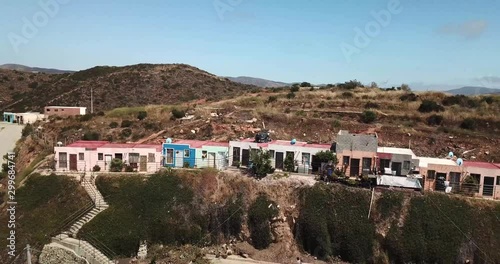 Drone footage of Haciendo Las Delicias, Baja, Mexico in the daytime. Starts with a wide angle then cinematically gets closer to the hillside homes photo