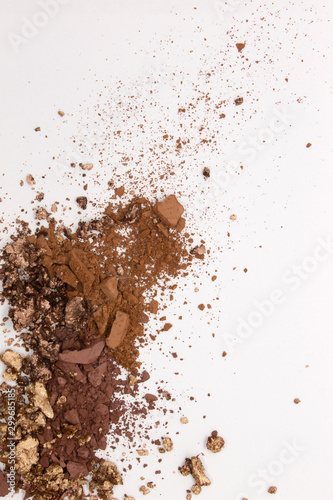 This is a photograph of a Matte Brown, Metallic Gold,and Deep Brown Powder Eyeshadow isolated on a White Background