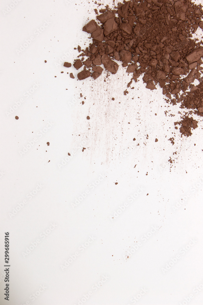 This is a photograph of a Dark Brown Powder Eyeshadow isolated on a White Background