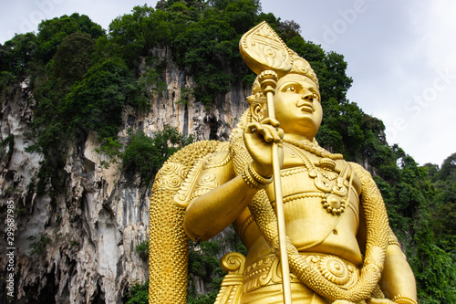 Photography Detail of upper part of golden statue at Batu Caves religious site located in Selangor, outside of Kuala Lumpur in Malaysia