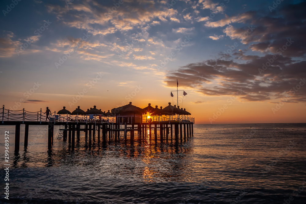 Sunrise on the pier of the sea.