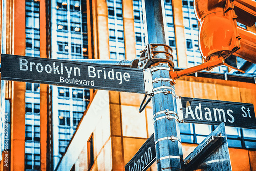 Street sign (nameplate) of Brooklyn Bridge and Adams Street and urban cityscape of New York. USA. photo
