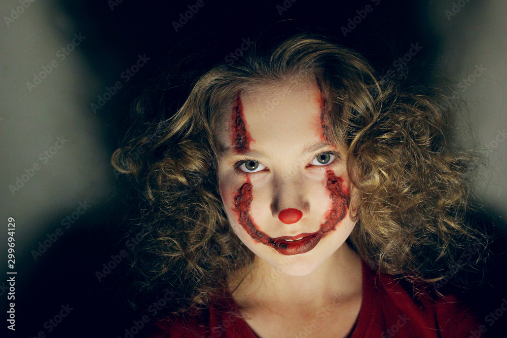 young woman with body painting on her face, ugly scary clown, Halloween  topic Stock Photo - Alamy