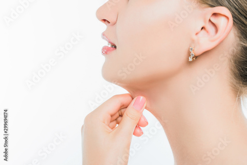 Portrait of a young slender girl pulling her second chin with her hand.