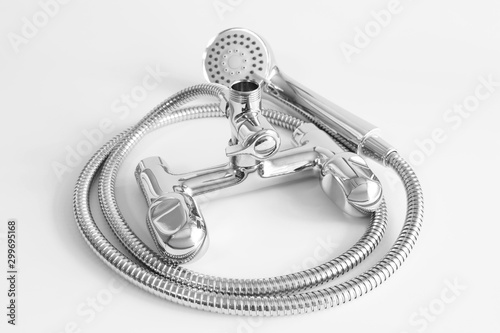 Water mixer and shower head for bathroom. Water tap made of chrome material on white background
