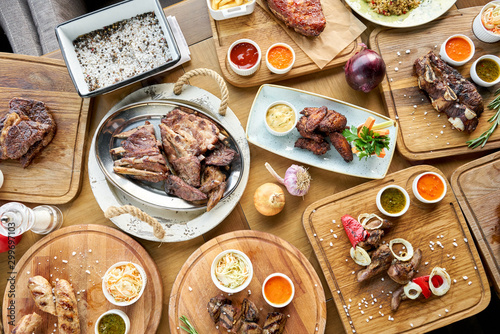 Barbecue restaurant menu. Many different food on the table. Dinner party or Banquet. Top view