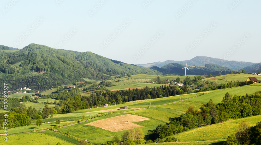 Beskid Sadecki Mountains in summer. View of village Rytro and wind turbine from village Przysietnica, Poland.