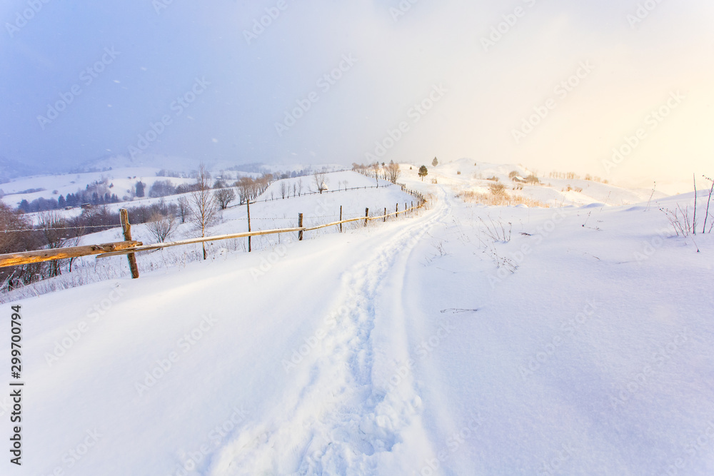 Heavy snowfall in morning in the mountains, rural landscape. Freezing day concept