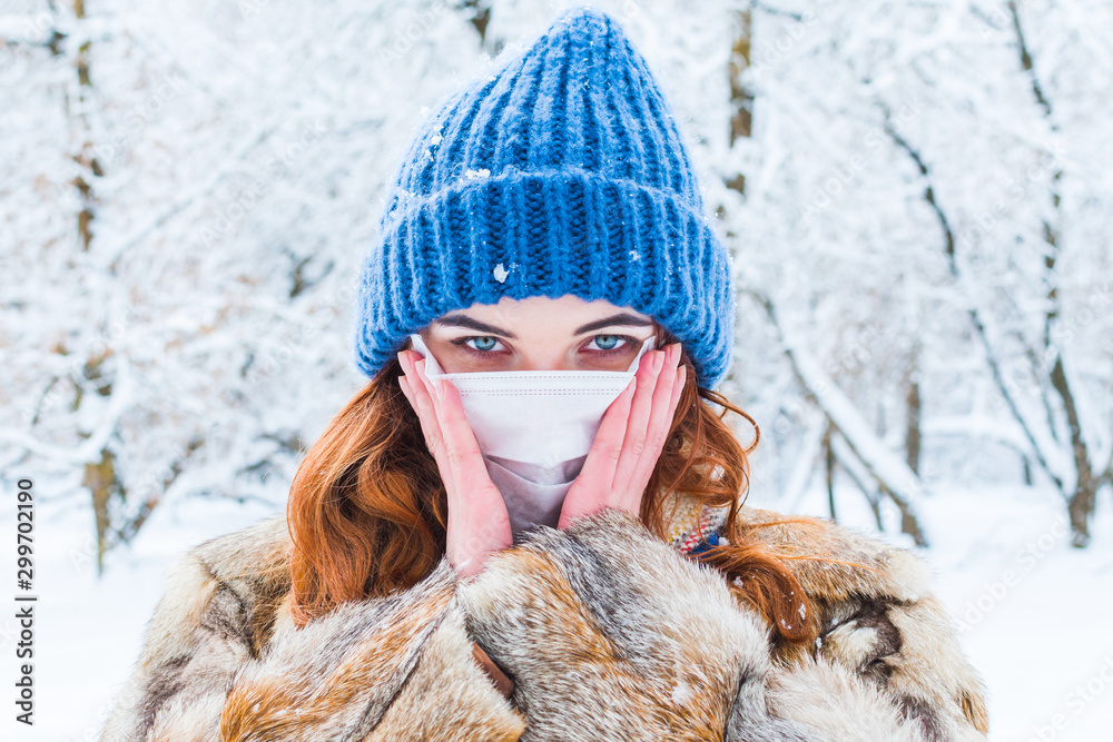young woman in protective mask in winter in outdoors young woman in protective mask in winter in outdoors