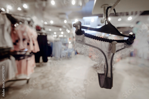 Fototapeta Naklejka Na Ścianę i Meble -  Gray lace underwear on hanger in lighted luxury store in shopping mall