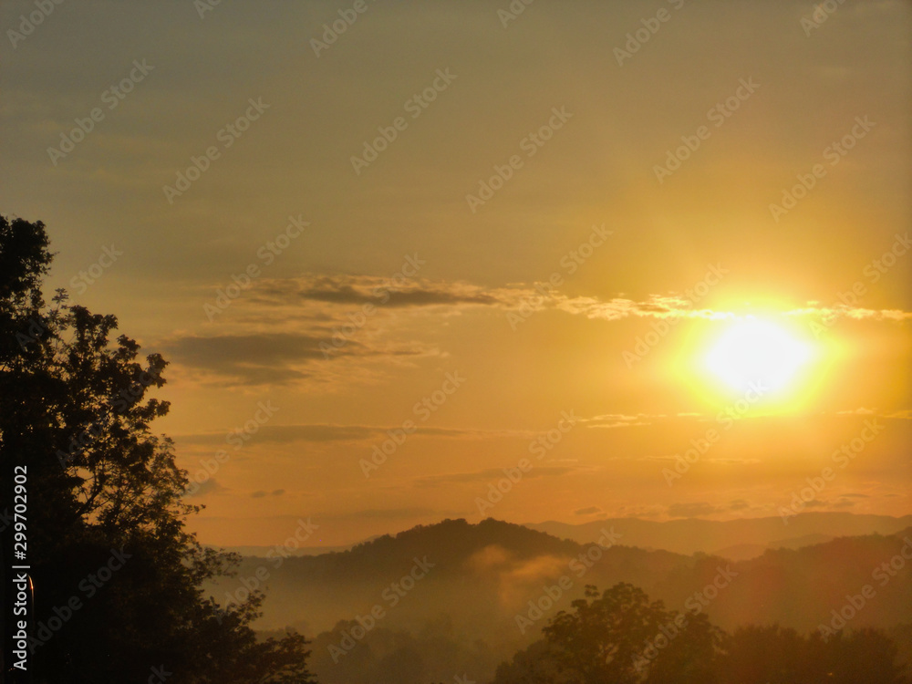 Bright, beautiful orange sunrise through the trees in the Appalachian Mountains
