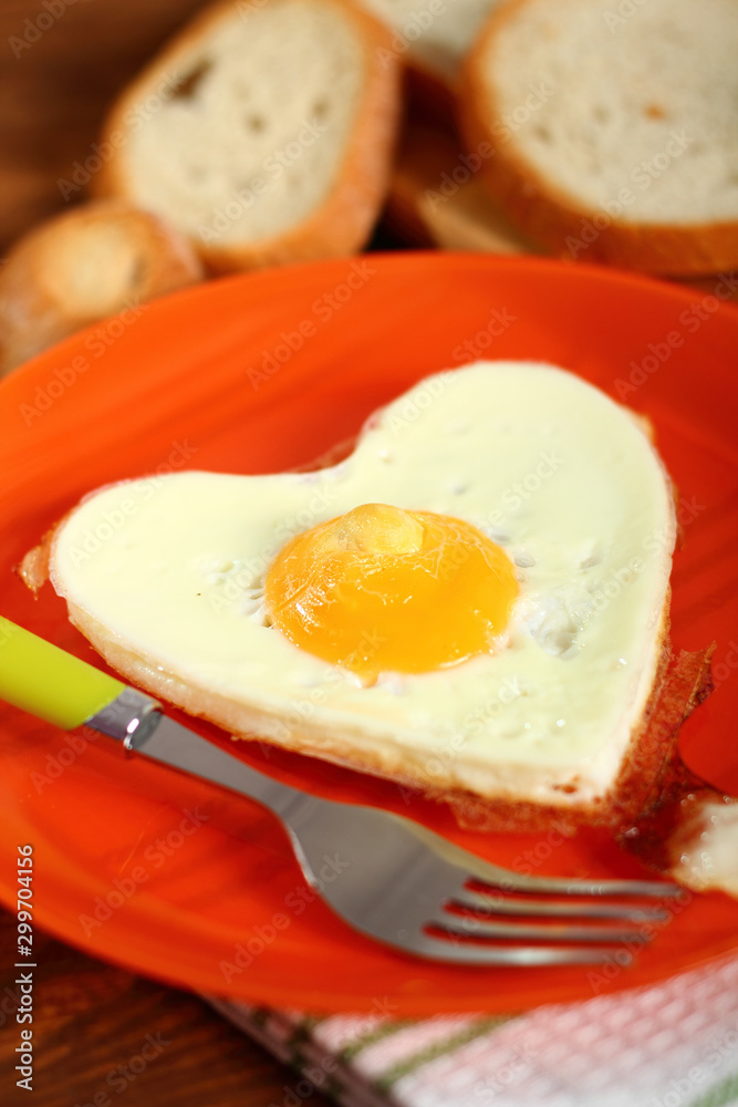 Fototapeta premium Fried Egg Sunny Side Up in Heart Shape
