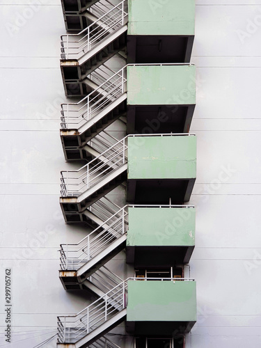 Staircase iron with rail is connected to the building used as a fire escape ladder.  Emergency Exit