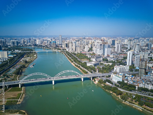 Aerial photos of high-rise residential area along the river and bridge across the river in the city
