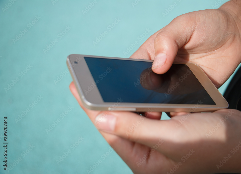 The girl's hands hold the phone smartphone and control the fingers The girl's hands hold the phone smartphone and control the fingers