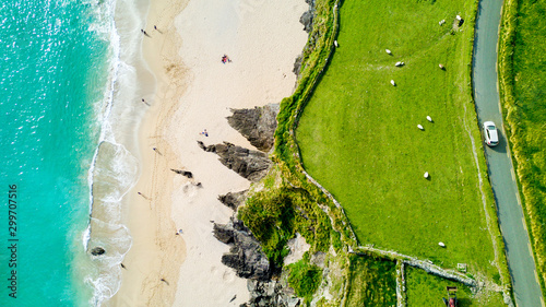 Car Driving Past Coumeenoole Bay, Dingle Peninsula, Ireland photo