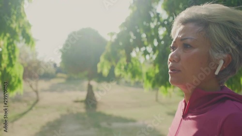 gimbal tracking shot on attractive middle aged lady running happy at city park . beautiful and sporty 40s woman exercising doing jogging workout enjoying healthy lifestyle and fitness