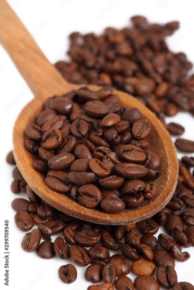 Fototapeta premium Coffee beans on wooden spoon. Isolated on white background. Macro.