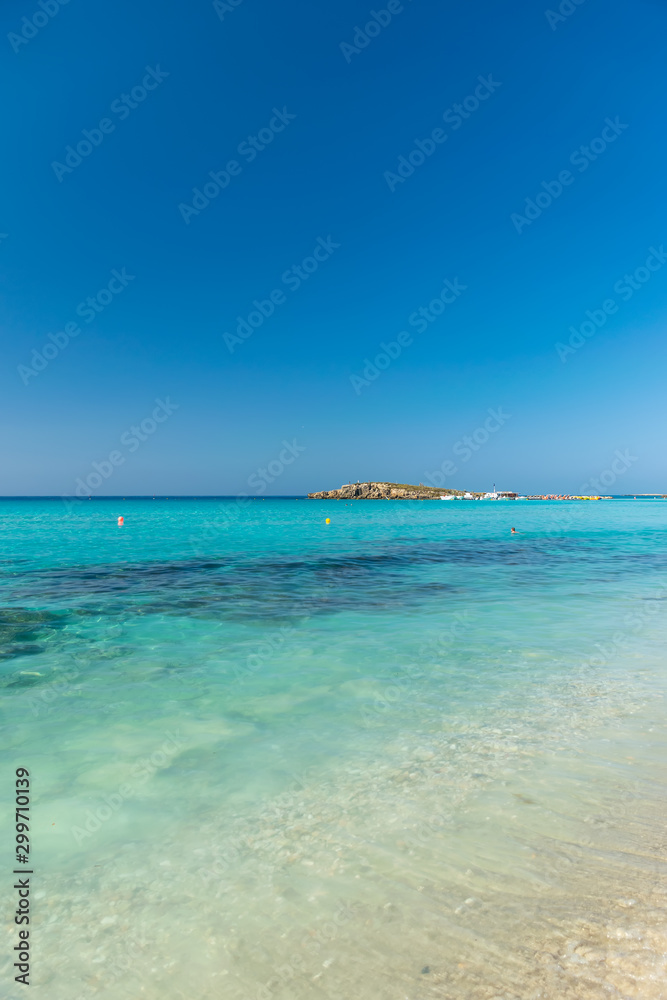 The most famous beach of Cyprus with crystal clear water. Nissi Beach.