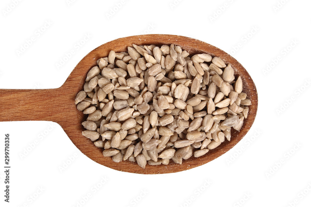 Sunflower seeds on wooden spoon. Isolated on white background. Directly Above. Sunflower seeds on wooden spoon. Isolated on white background. Directly Above.