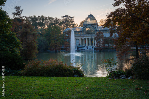 Sunset view of Crystal Palace or Palacio de cristal in Retiro Park in Madrid, Spain. The Buen Retiro Park is one of the largest parks of the city of Madrid, Spain