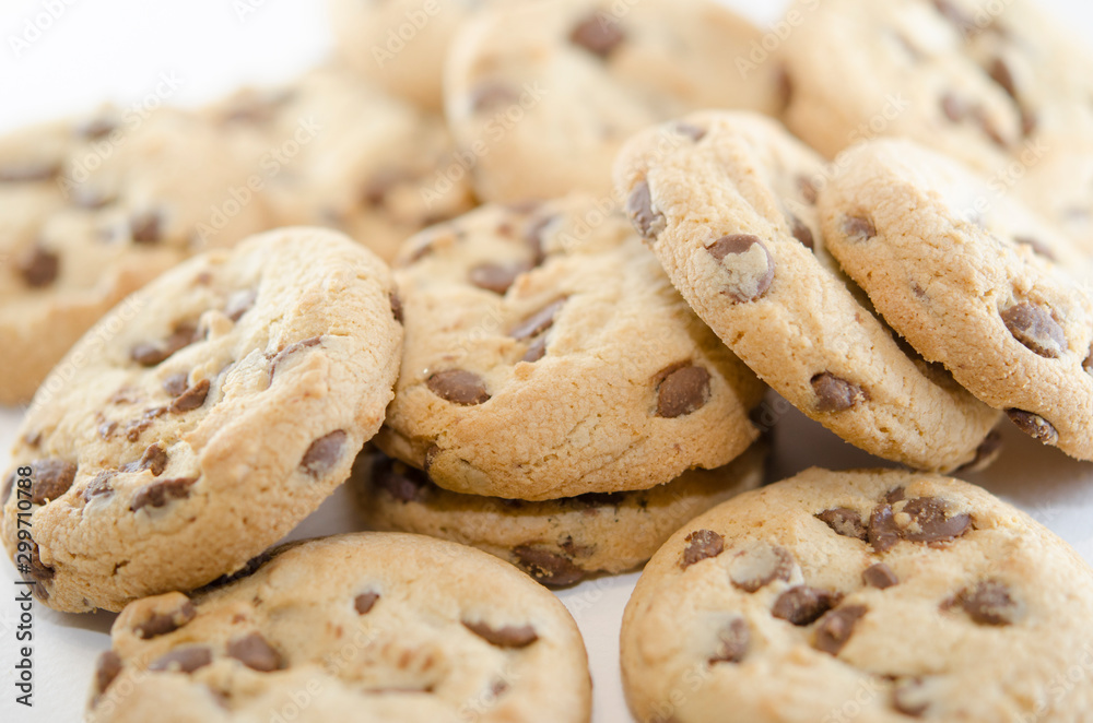 Close up on cookies with dark chocolate chips on the white background. Dessert or pastries Close up on cookies with dark chocolate chips on the white background. Dessert or pastries