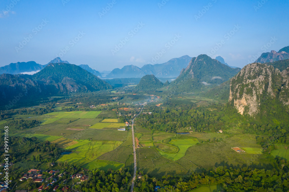 Aerial view of village Vang Vieng and  Nam Song river , Laos. Southeast Asia. Photo made by drone from above. Bird eye view.