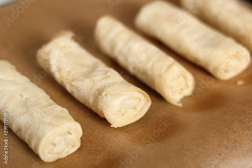 Raw spring roll on baking tray