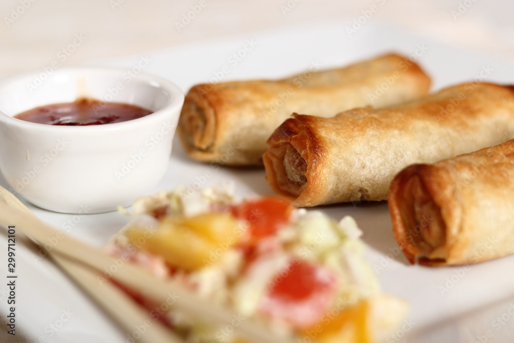 Spring roll with salad and chili sauce on plate Spring roll with salad and chili sauce on plate
