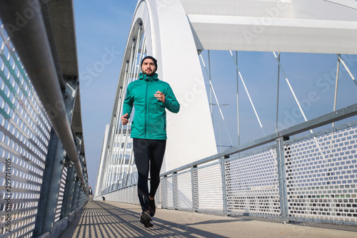 Young man running outdoors in morning