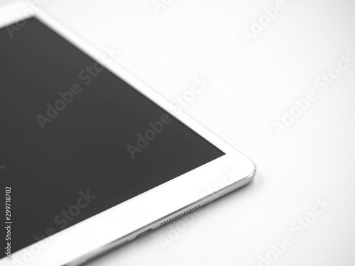 Closeup of white tablet with black touch screen display on gray background.