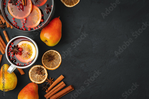 Vászonkép Top view of  hot mulled wine and spices on black background