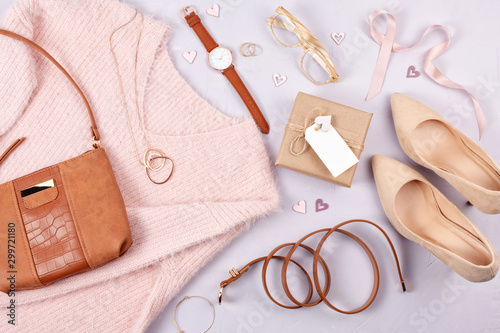 Flat lay of woman clothing and accessories in pastel colors photo