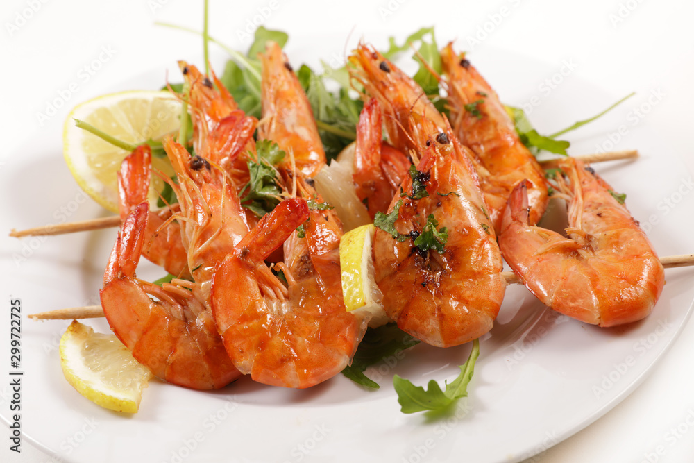 fried shrimp skewer with lemon and salad isolated on white background