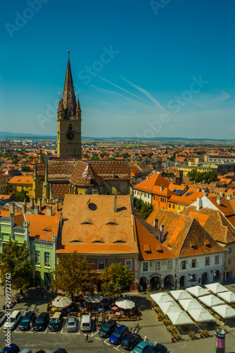 Aerial overview of Sibiu, Romania from the Council Tower with the Small Square Piata Mica and the ramp heading to the Lower town, while the Evanghelical Lutheran Cathedral dominates the skyline. photo