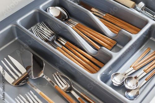 Stylish cutlery with wood-effect handles in organizer. Scandinavian style, hygge.