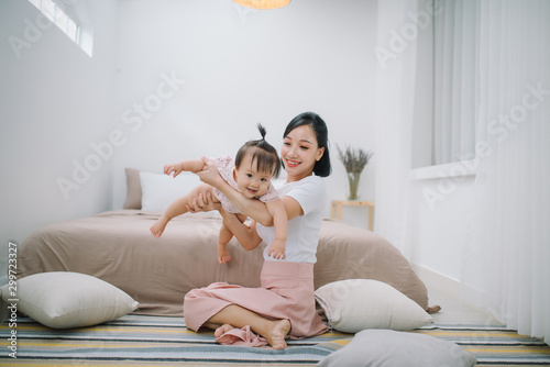 portrait of asian mother and baby relaxing in the room
