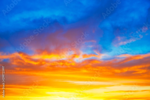 Sunset blue orange sky with sun and colorful clouds © Pavlo Vakhrushev
