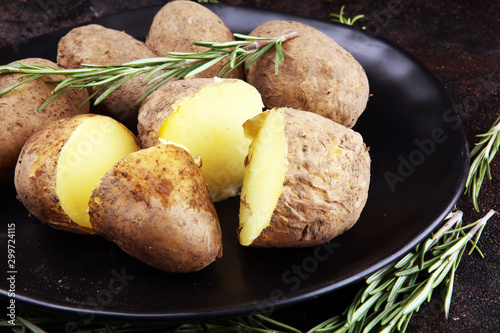 Pile of potatoes lying on a dish. Fresh boiled half potato and rosemary