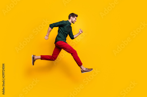Foto Full size profile side photo of positive cheerful guy jump run fast want hurry t