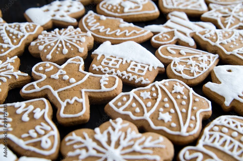Christmas gingerbread of different kinds on a black and white wooden background