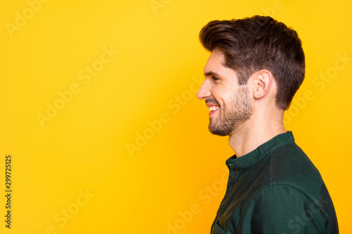 Porfile side photo of satisfied guy feel positive cheerful emotion look listen to his friends on summer holidays enjoy free time wear casual style clothes isolated over yellow color background photo