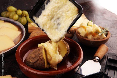 Photography raclette cheese melted served in individual raclette skillets